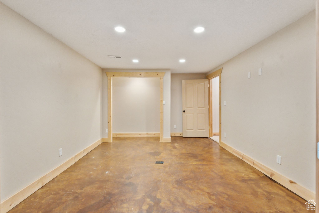 Unfurnished room with recessed lighting, finished concrete floors, and baseboards