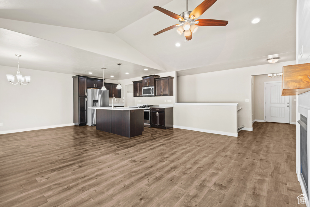 Kitchen featuring open floor plan, appliances with stainless steel finishes, light countertops, a chandelier, and recessed lighting