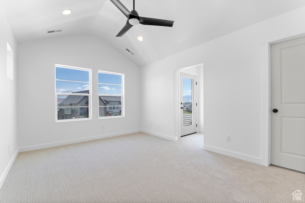 Unfurnished room featuring a ceiling fan, lofted ceiling, light carpet, baseboards, and recessed lighting