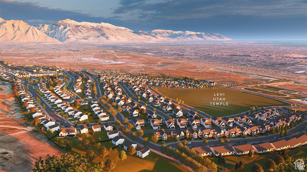 Aerial view of property's location with a mountainous background and nearby suburban area