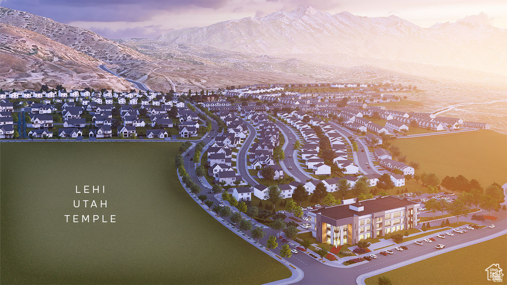 Aerial overview of property's location with a mountain backdrop and nearby suburban area