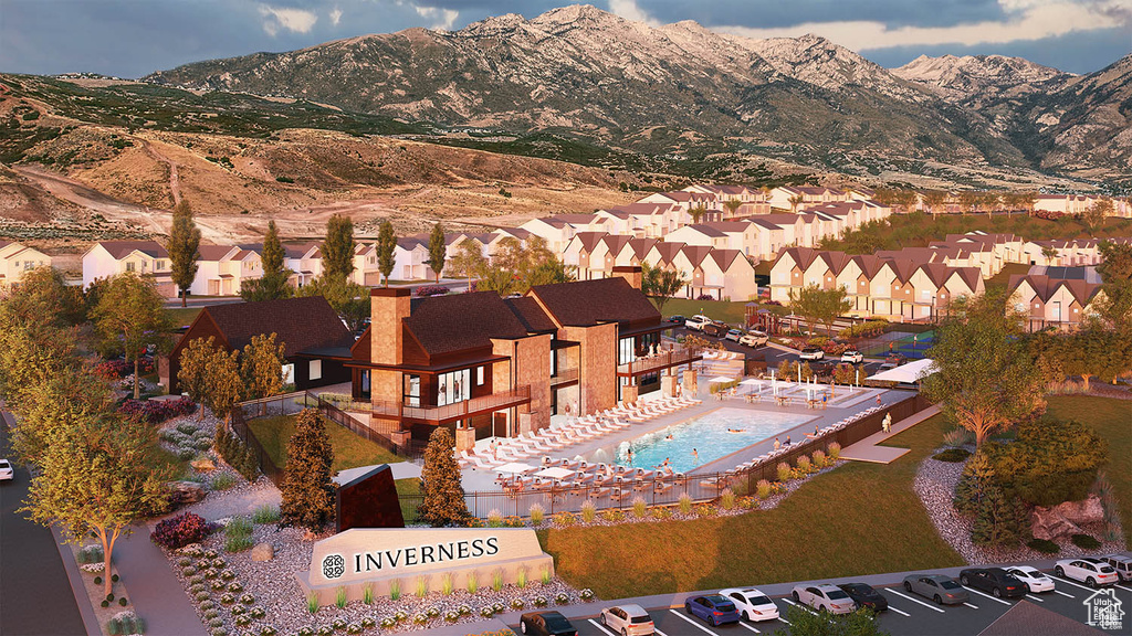 Aerial perspective of suburban area with a pool area and mountains
