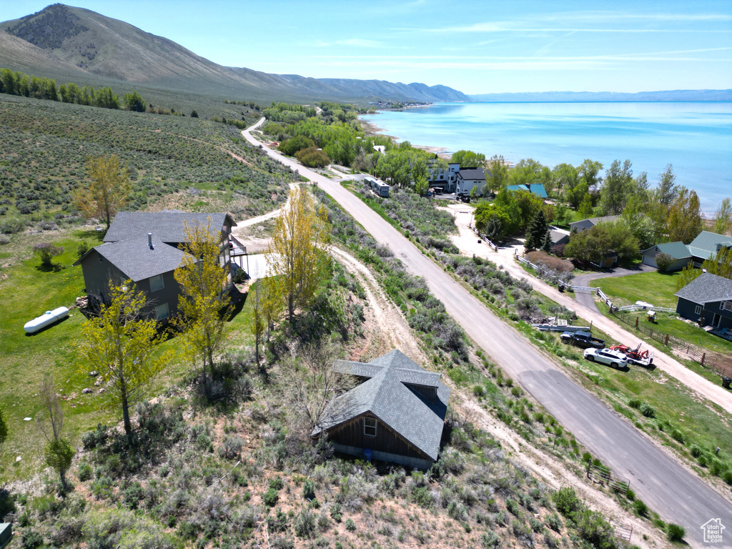 View of subject property with a water and mountain view