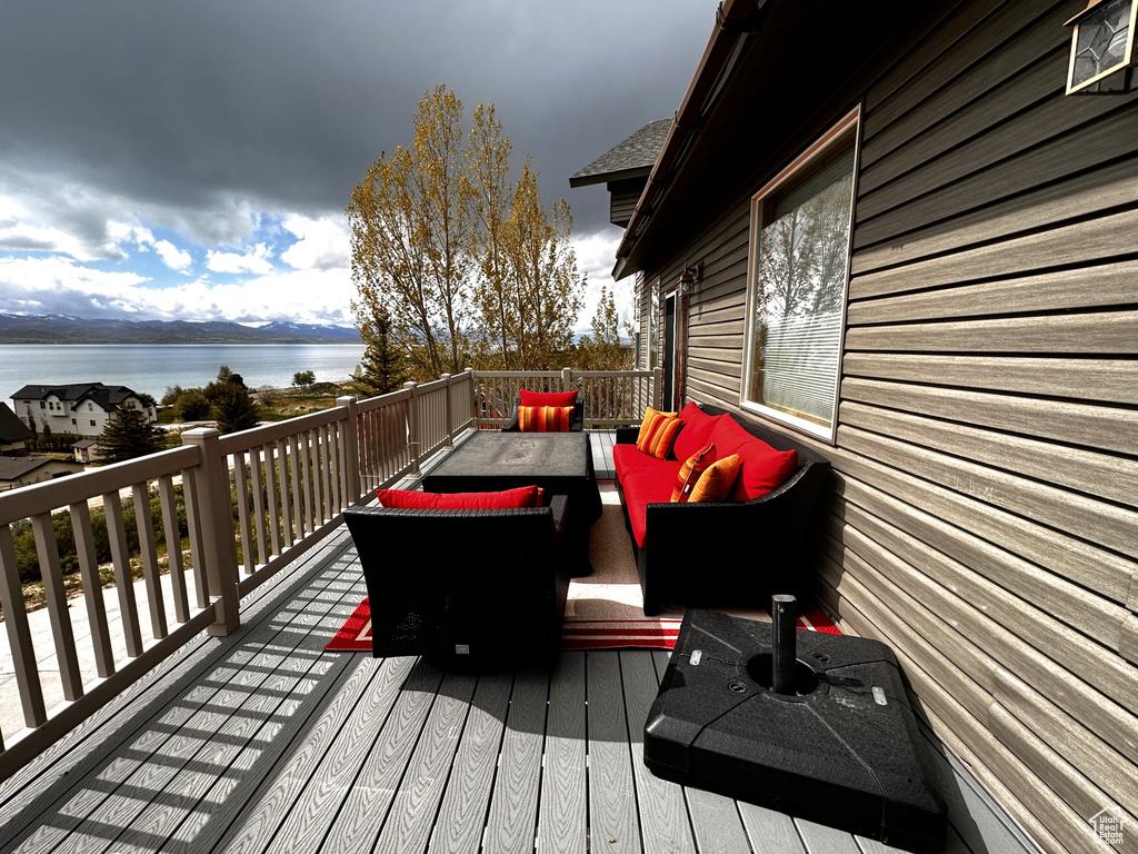Deck featuring an outdoor living space and a water view