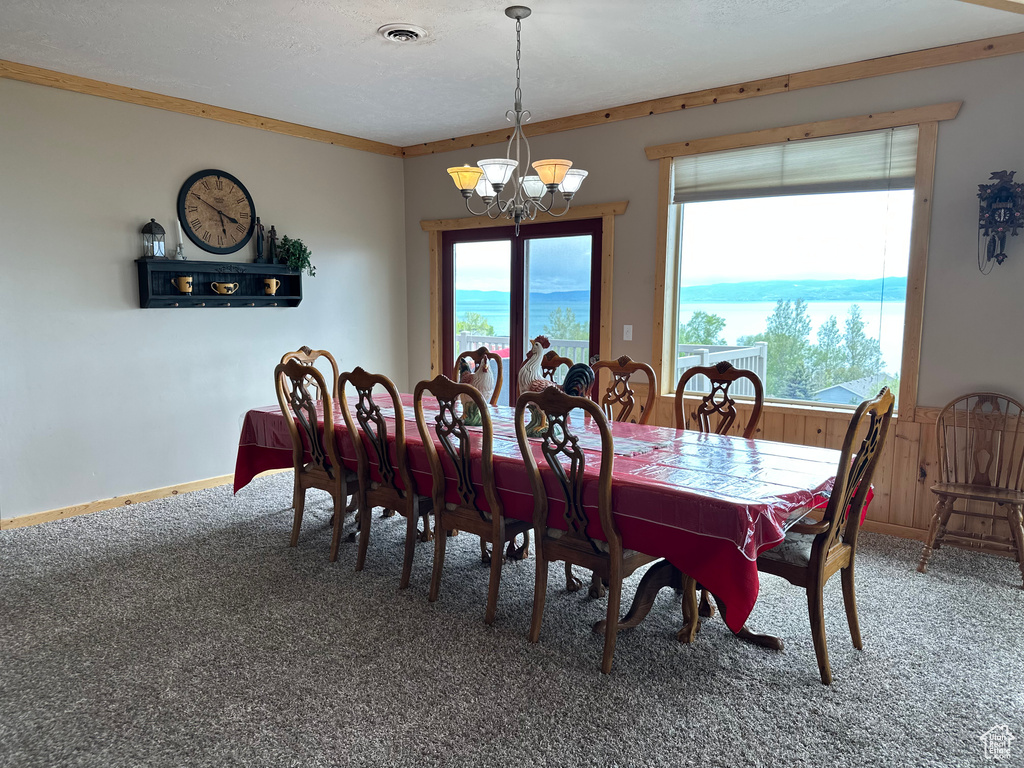 Dining area with a chandelier and carpet