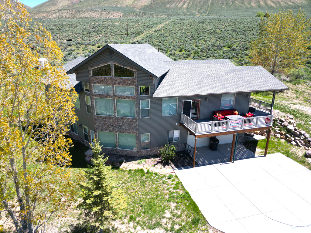 Back of house featuring roof with shingles and a mountain view