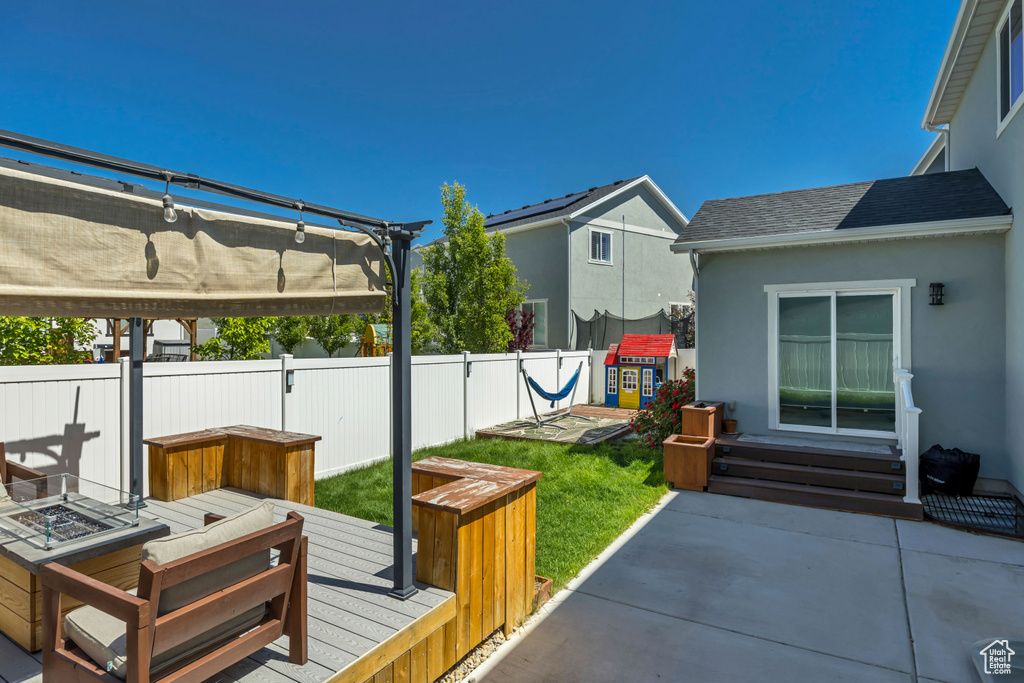 View of patio / terrace featuring an outdoor fire pit, a pergola, a jacuzzi, and a wooden deck
