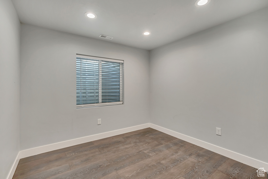 Unfurnished room featuring recessed lighting, baseboards, and dark wood finished floors