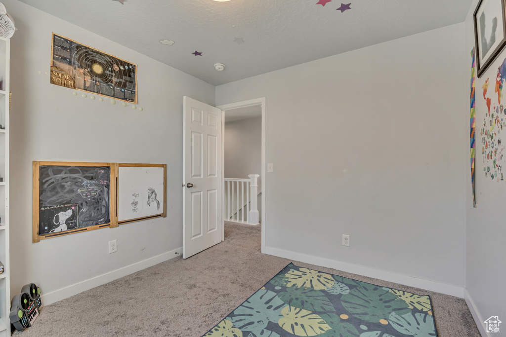 Unfurnished bedroom with carpet floors and baseboards