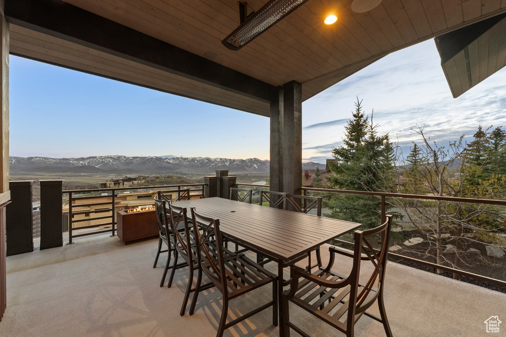 Balcony featuring a mountain view and outdoor dining area