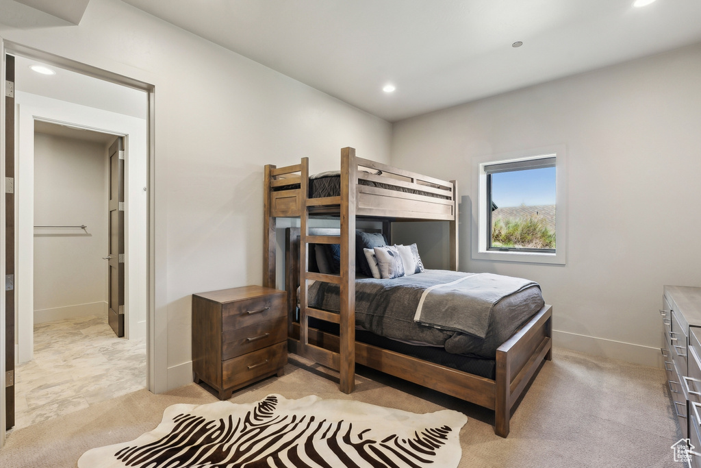 Bedroom with light carpet, baseboards, and recessed lighting