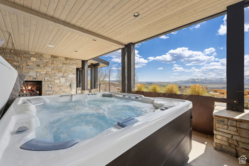 Misc room with wood ceiling, a jacuzzi, and a mountain view