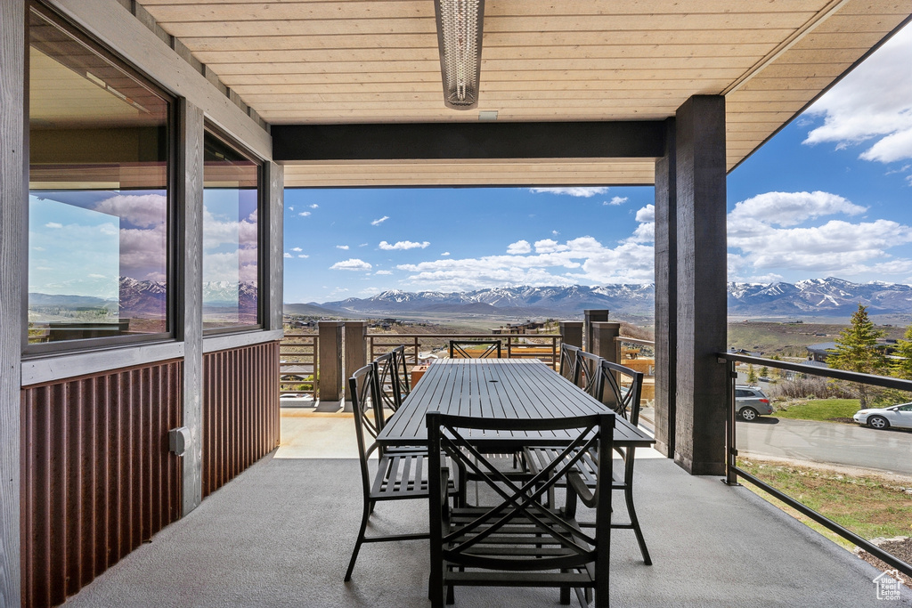 Balcony with outdoor dining space and a mountain view