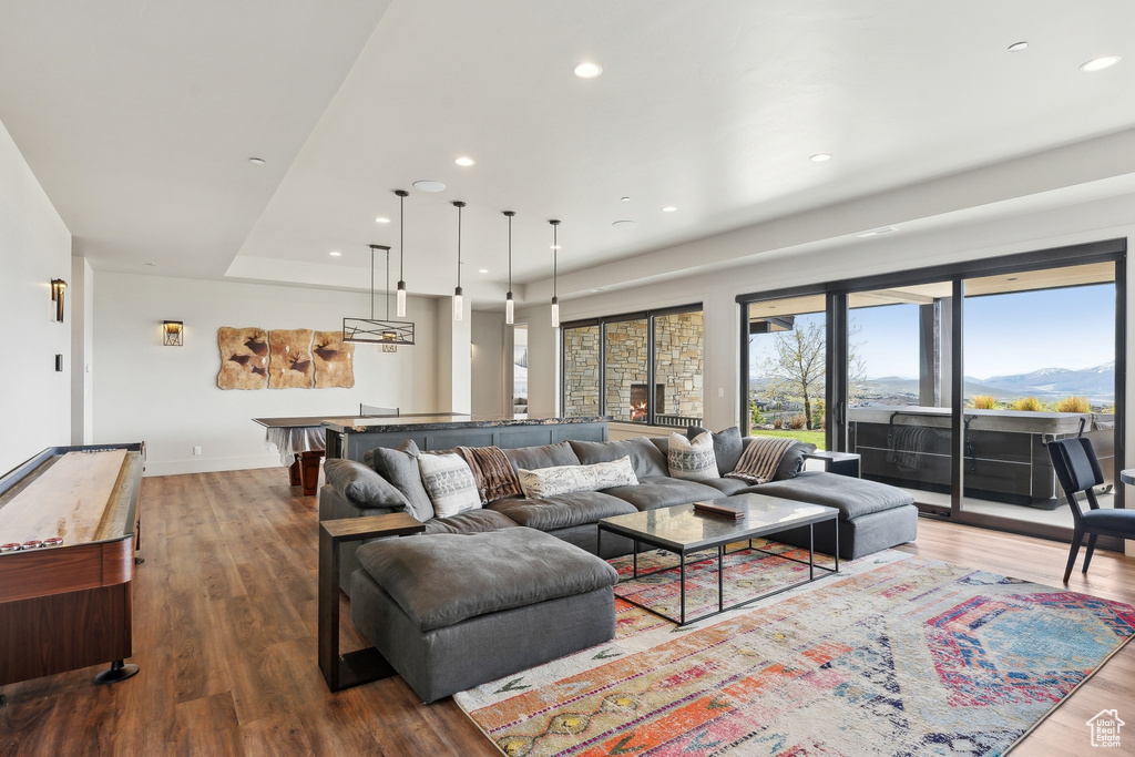 Living area featuring wood finished floors, baseboards, and recessed lighting