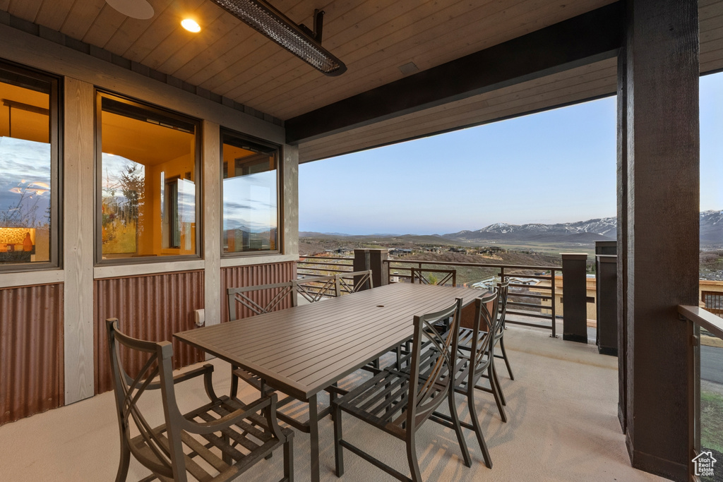Balcony with outdoor dining area and a mountain view