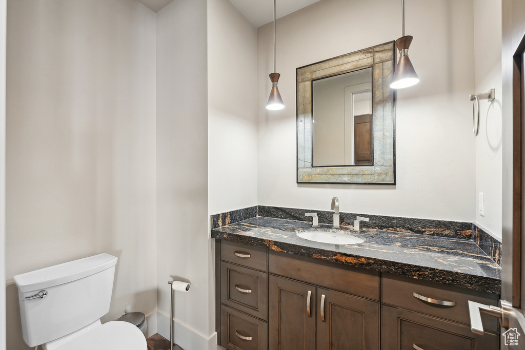 Half bath featuring vanity and toilet