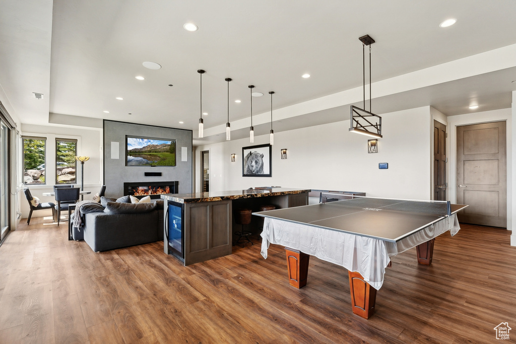 Playroom featuring billiards, a large fireplace, recessed lighting, and wood finished floors