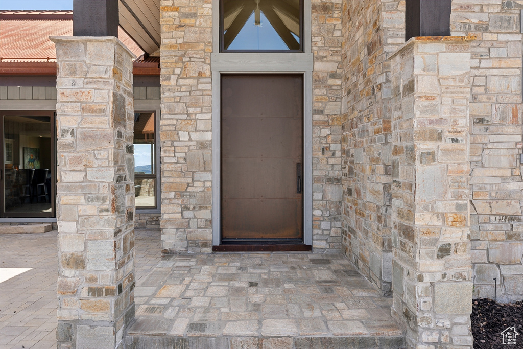 Doorway to property featuring stone siding
