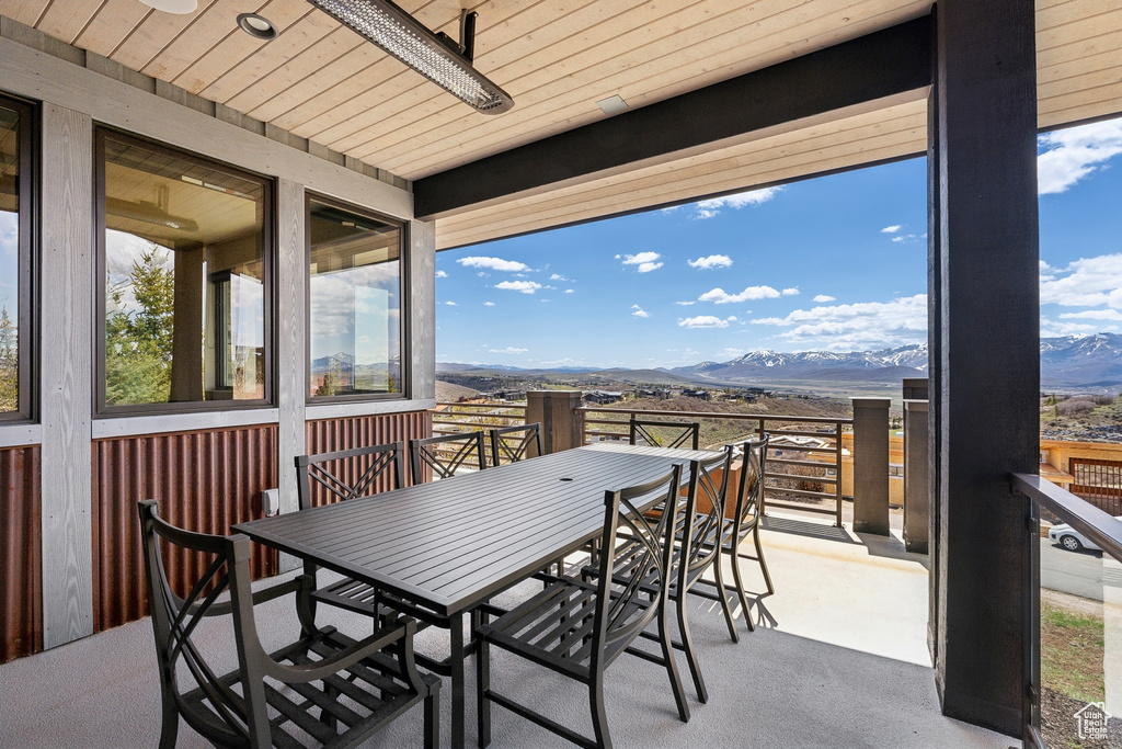 Exterior space with outdoor dining space, a mountain view, and plenty of natural light
