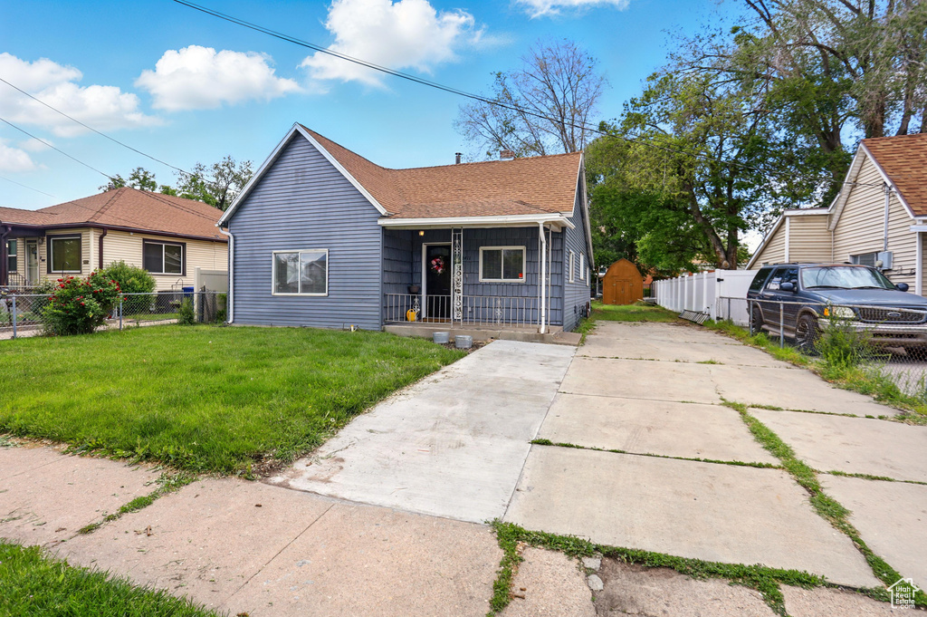 Bungalow-style house with a porch, driveway, and roof with shingles