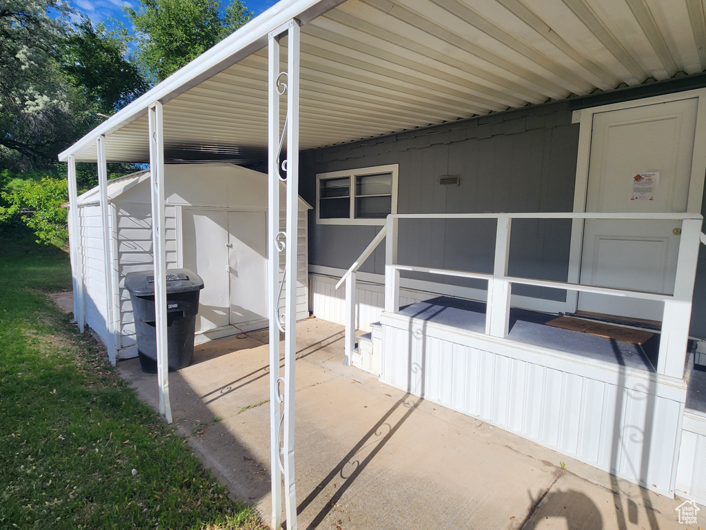 View of home\\\'s exterior featuring a patio and a storage unit