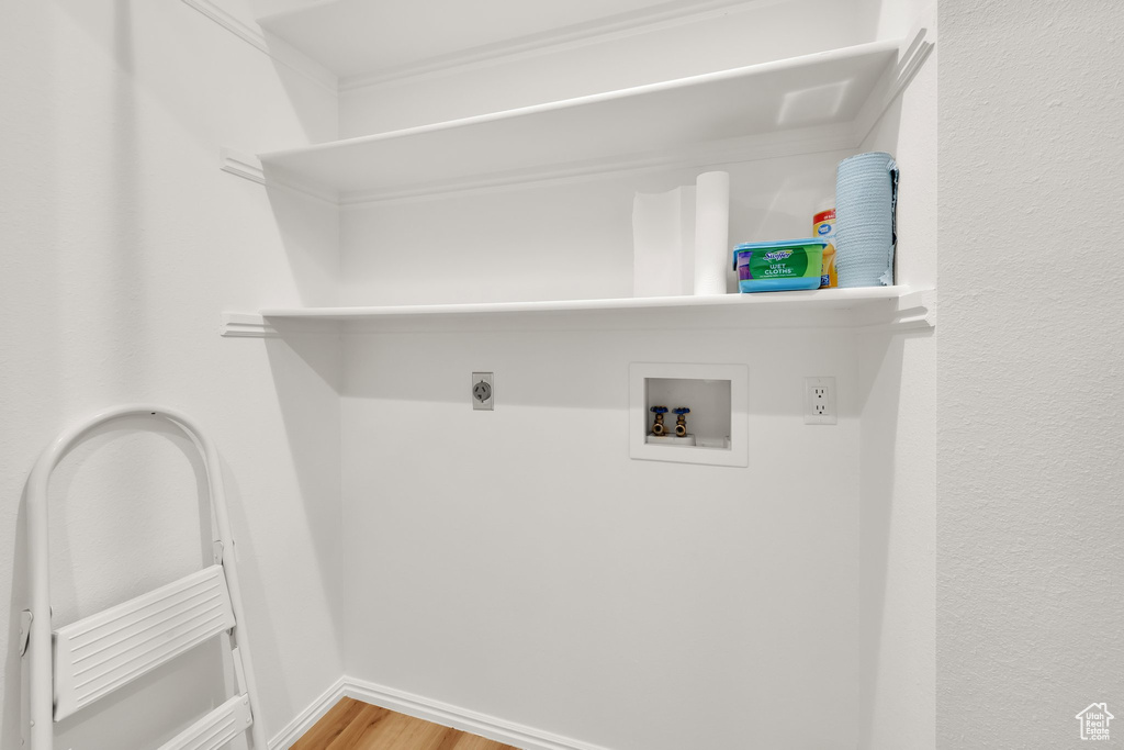 Washroom featuring hookup for a washing machine, wood finished floors, and electric dryer hookup