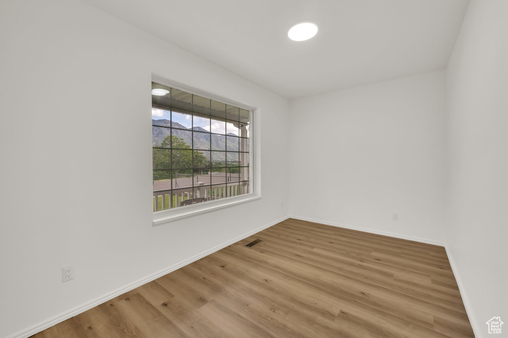Empty room featuring wood finished floors and baseboards