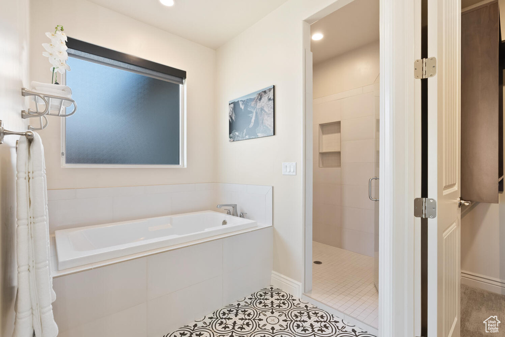 Full bathroom featuring a shower stall, a bath, tile patterned floors, baseboards, and recessed lighting