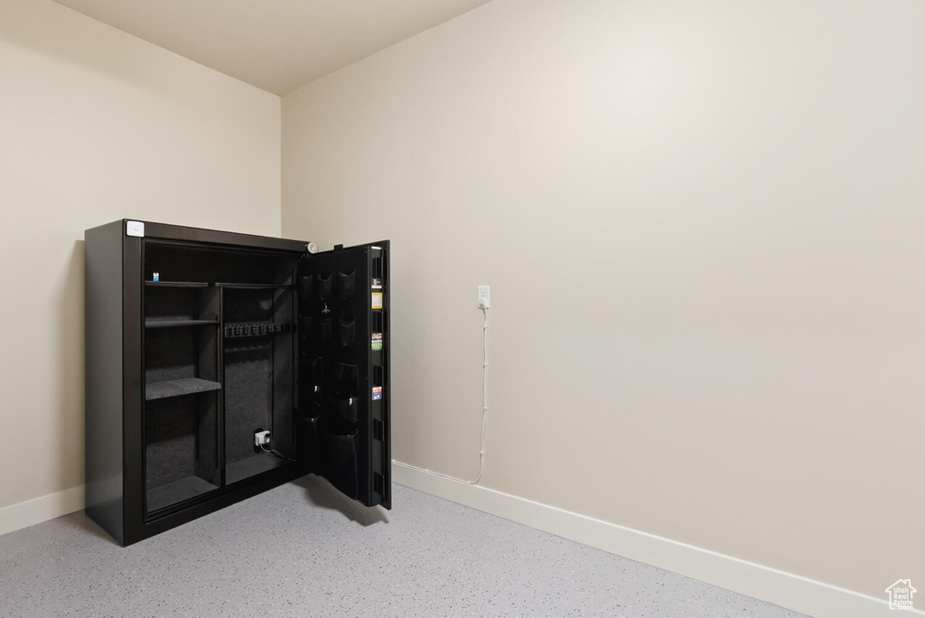 Unfurnished bedroom featuring baseboards and speckle patterned floor