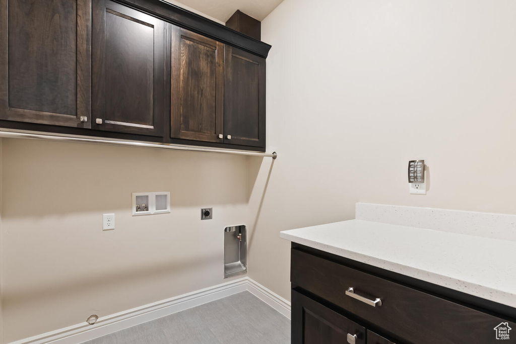Laundry area featuring hookup for a washing machine, hookup for an electric dryer, cabinet space, baseboards, and hookup for a gas dryer