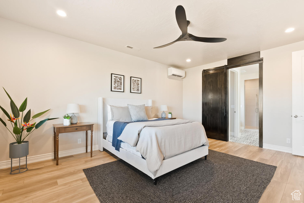 Bedroom featuring light wood-style floors, a wall mounted air conditioner, recessed lighting, and a ceiling fan
