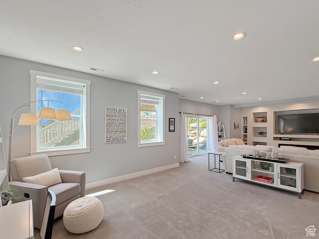 Living room with recessed lighting, carpet, and baseboards