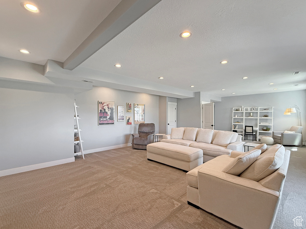 Living room featuring light colored carpet, recessed lighting, and baseboards