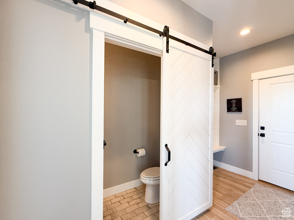 Bathroom featuring toilet, recessed lighting, and baseboards