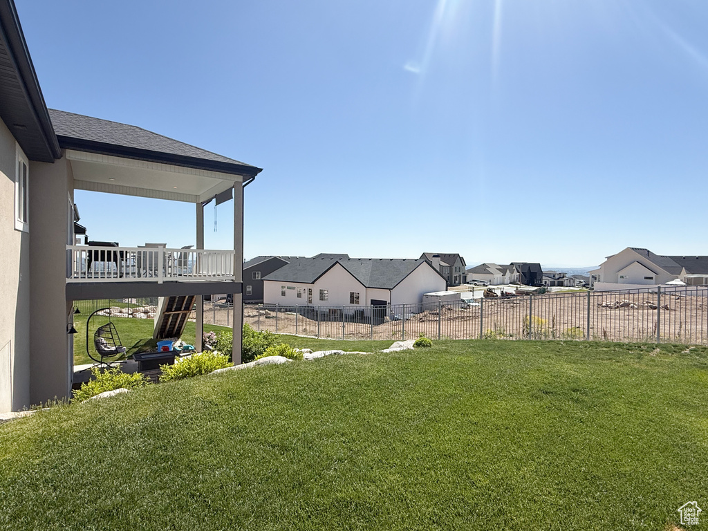 View of yard with a residential view and a wooden deck