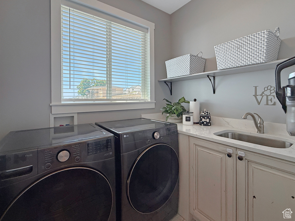 Laundry room with washer and clothes dryer and cabinet space