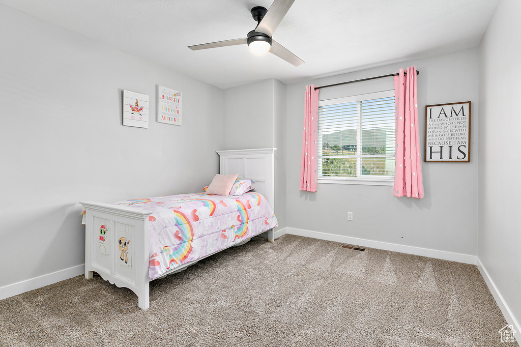 Bedroom featuring baseboards and carpet floors