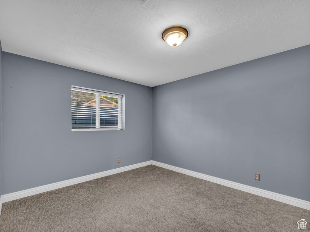 Spare room with carpet floors and baseboards