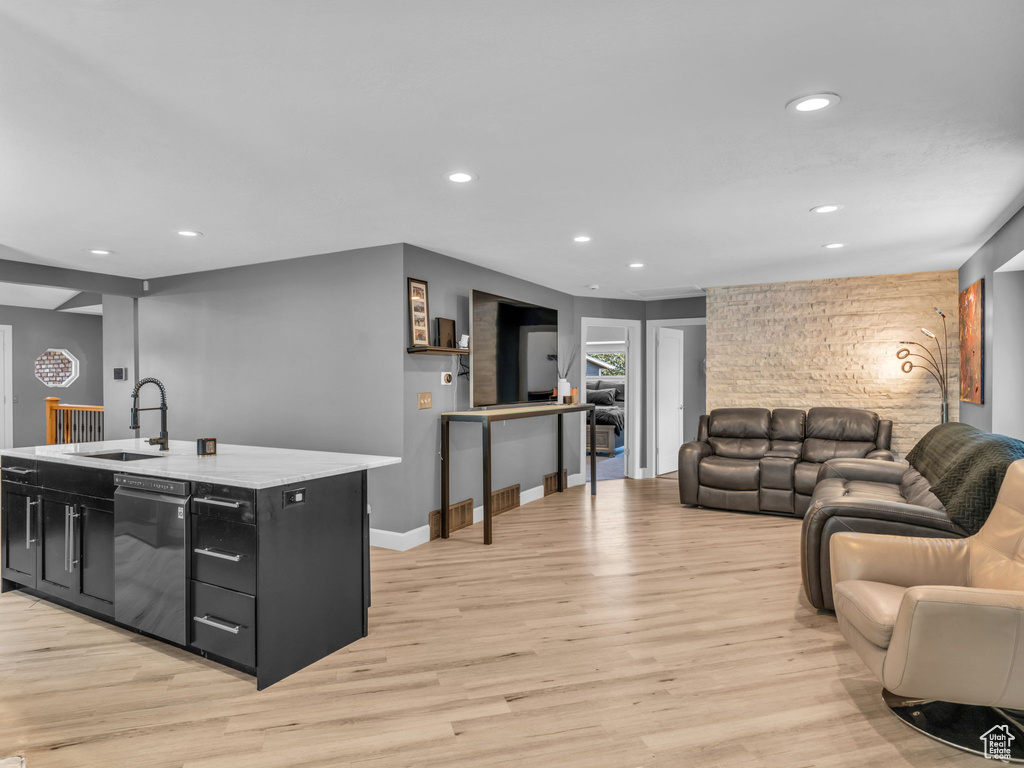 Living area with recessed lighting, light wood-type flooring, and baseboards