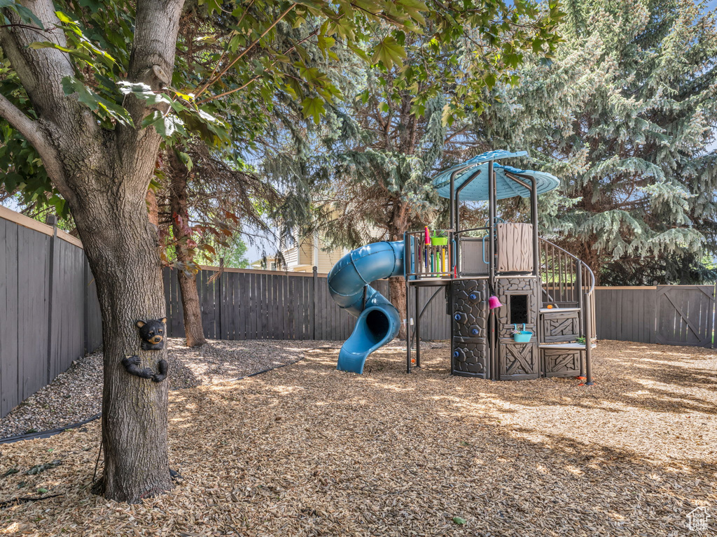 View of play area with a fenced backyard