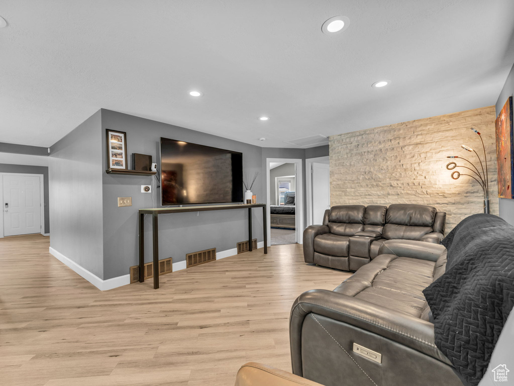 Living area featuring baseboards, recessed lighting, and light wood finished floors