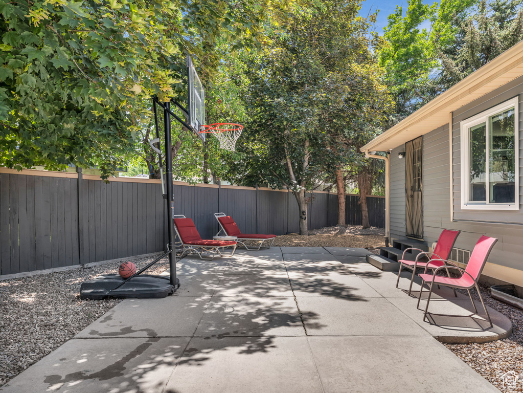 Fenced backyard with a patio area and entry steps