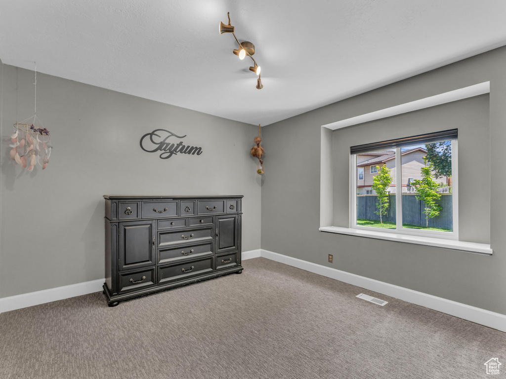 Unfurnished bedroom with carpet floors and baseboards