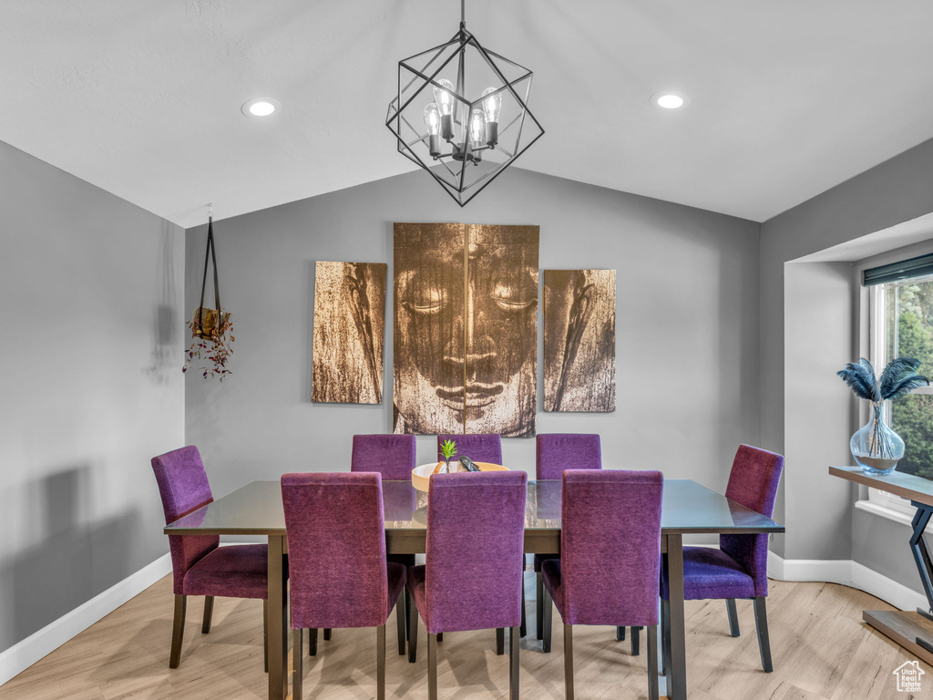 Dining area with vaulted ceiling, baseboards, wood finished floors, a chandelier, and recessed lighting