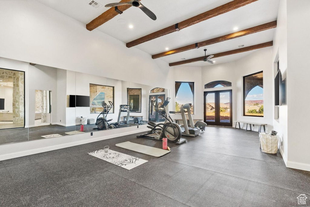 Exercise area featuring ceiling fan, baseboards, a high ceiling, recessed lighting, and french doors