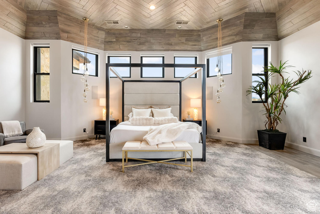 Bedroom featuring wooden ceiling, baseboards, lofted ceiling, and wood finished floors
