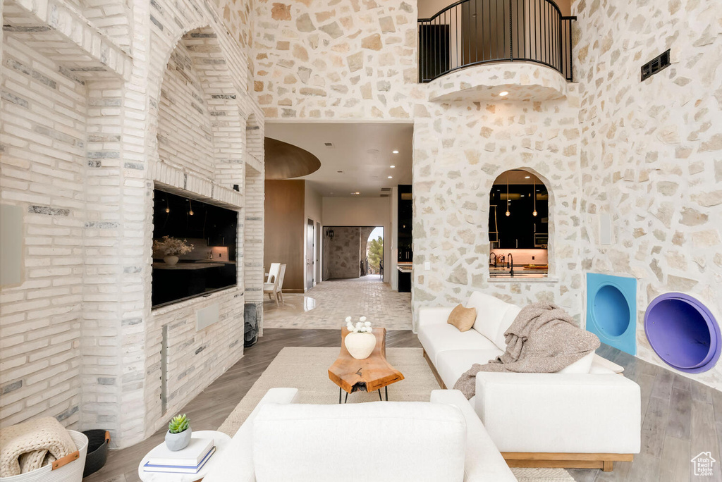 Living room featuring a towering ceiling and wood finished floors