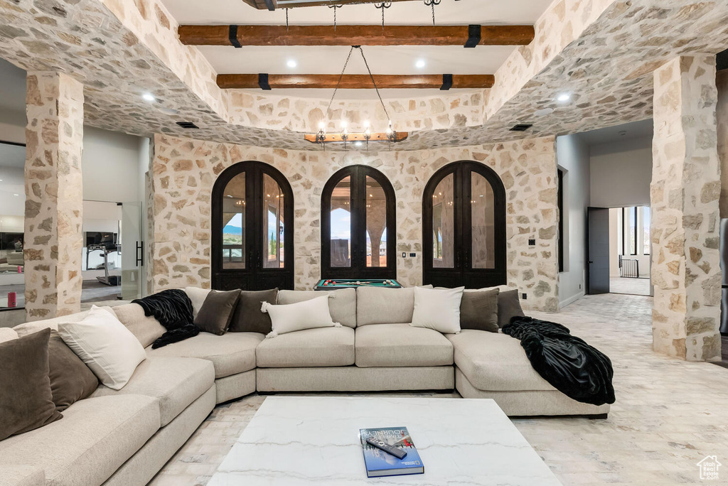 Living room with beamed ceiling and a chandelier