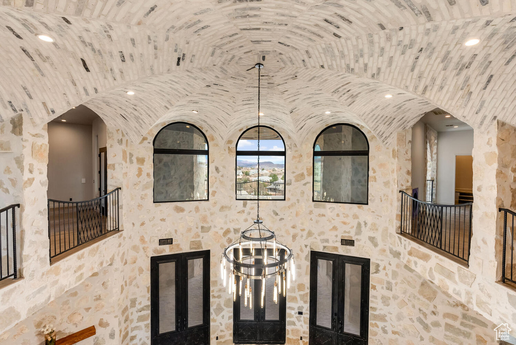 Detailed view of arched walkways, a chandelier, and recessed lighting