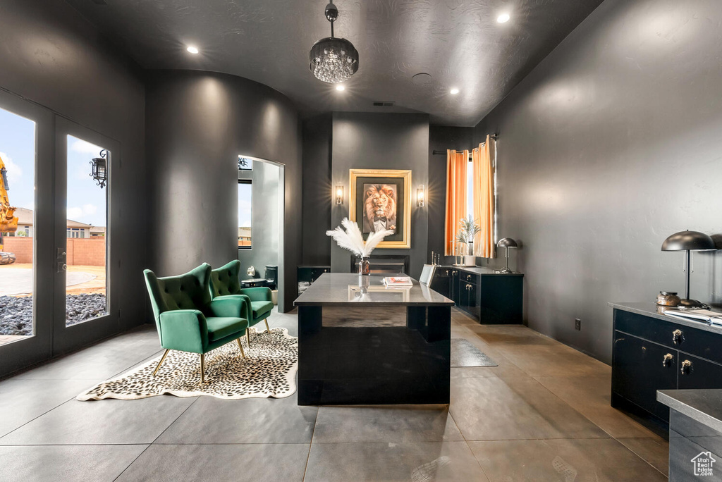 Interior space featuring two vanities, recessed lighting, french doors, and concrete floors